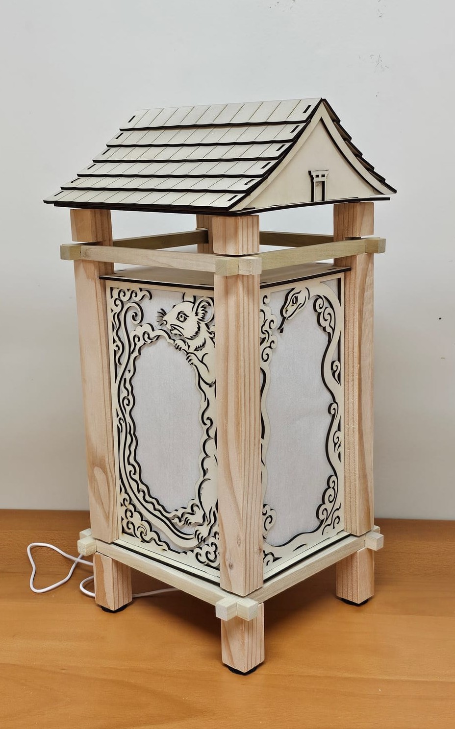 The finished natural-wood lantern with its shingled roof in place
